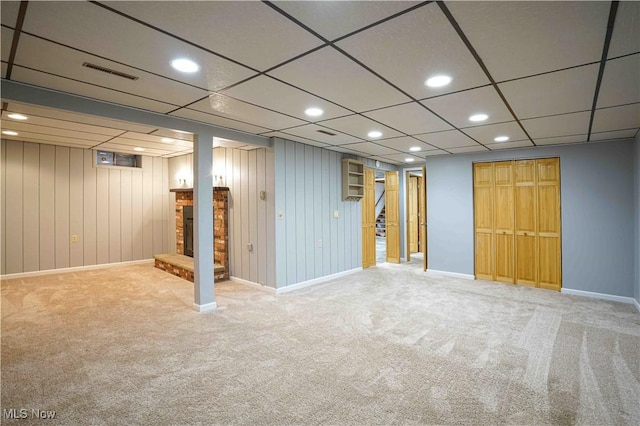 basement featuring a fireplace and carpet flooring