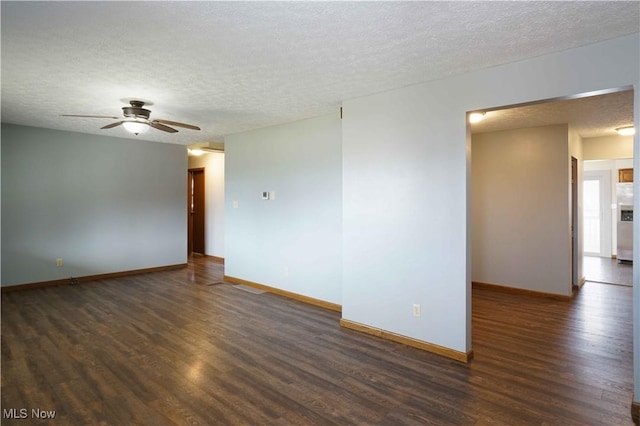 spare room with dark wood-type flooring, ceiling fan, and a textured ceiling