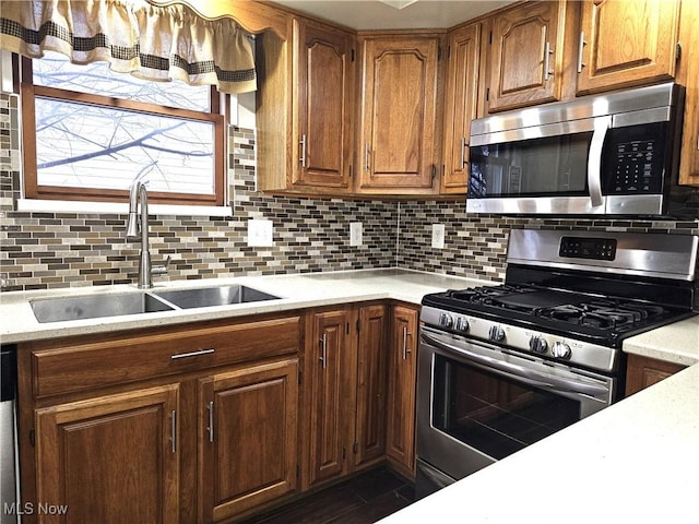 kitchen with sink, backsplash, and appliances with stainless steel finishes