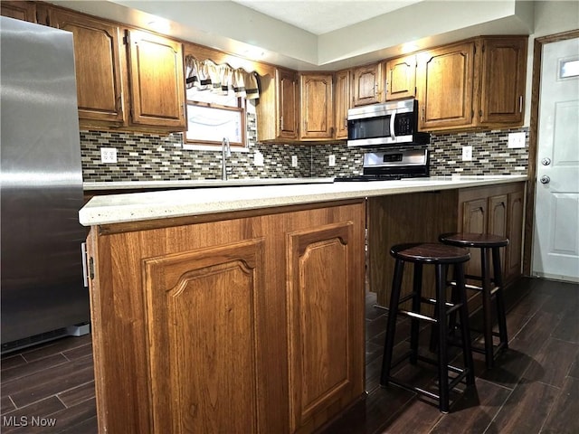 kitchen featuring tasteful backsplash, stainless steel appliances, and sink