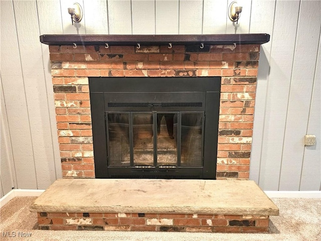 room details with a brick fireplace and carpet