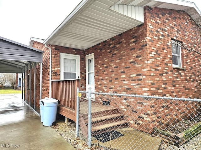 doorway to property featuring a carport