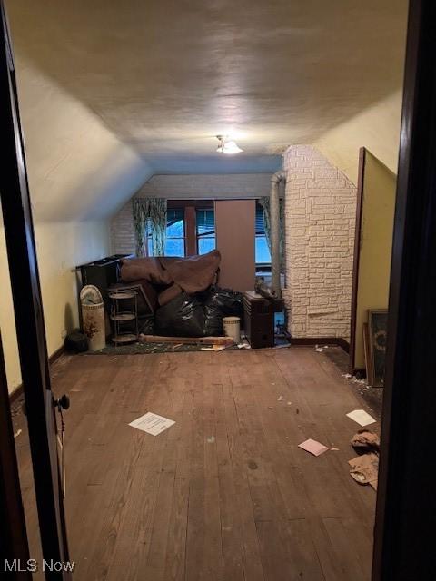 bonus room featuring hardwood / wood-style flooring and lofted ceiling