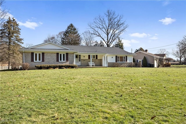 ranch-style home featuring a porch and a front yard