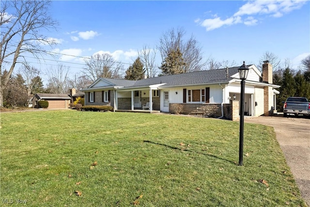 ranch-style home featuring a garage, a front lawn, and a porch