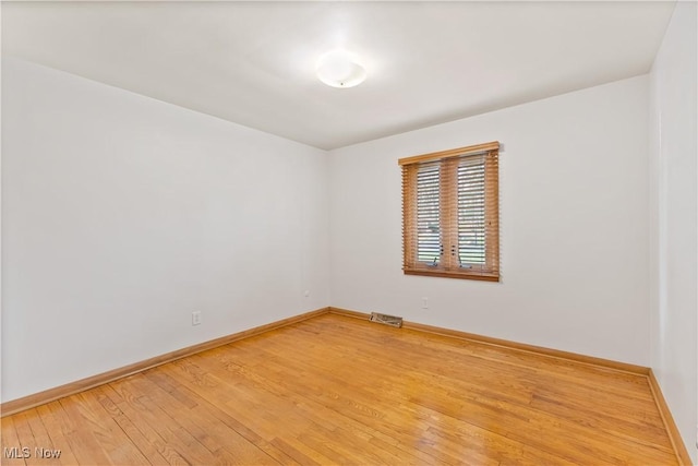 empty room with hardwood / wood-style floors