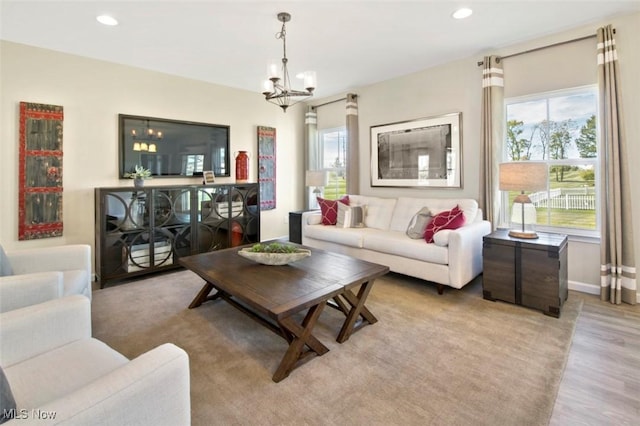 living room featuring light hardwood / wood-style flooring and a notable chandelier