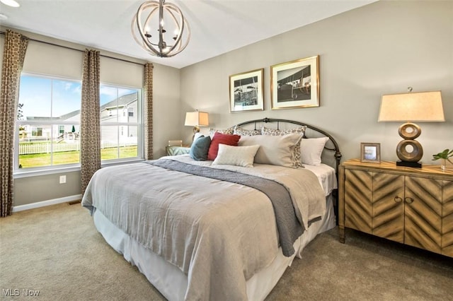 carpeted bedroom featuring a notable chandelier