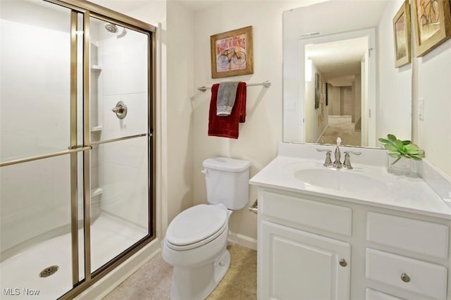 bathroom with walk in shower, vanity, toilet, and tile patterned flooring