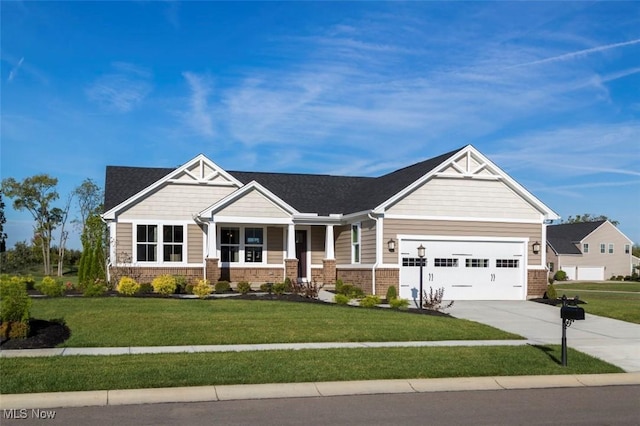 craftsman house with a garage and a front yard