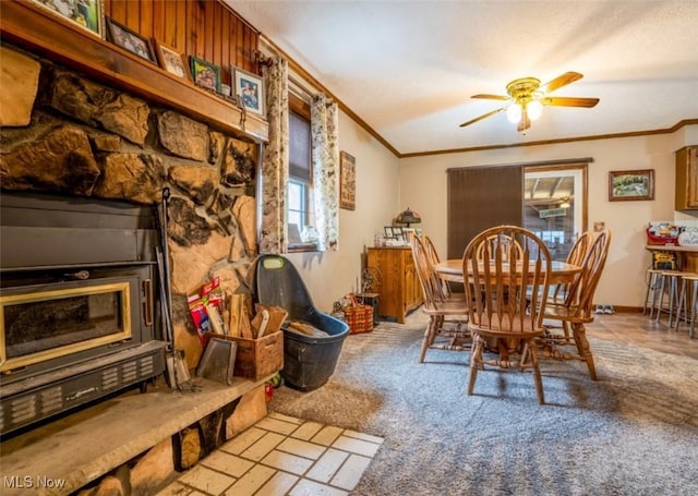 dining room with crown molding, light colored carpet, and ceiling fan