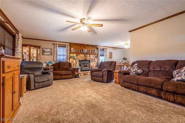 carpeted living room with crown molding, a textured ceiling, and ceiling fan