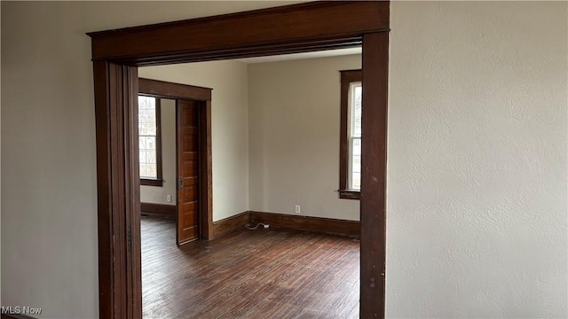 unfurnished room with dark hardwood / wood-style flooring