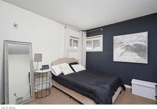 carpeted bedroom featuring a textured ceiling