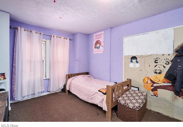 carpeted bedroom featuring a textured ceiling