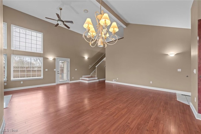 unfurnished living room with beamed ceiling, wood-type flooring, ceiling fan with notable chandelier, and high vaulted ceiling