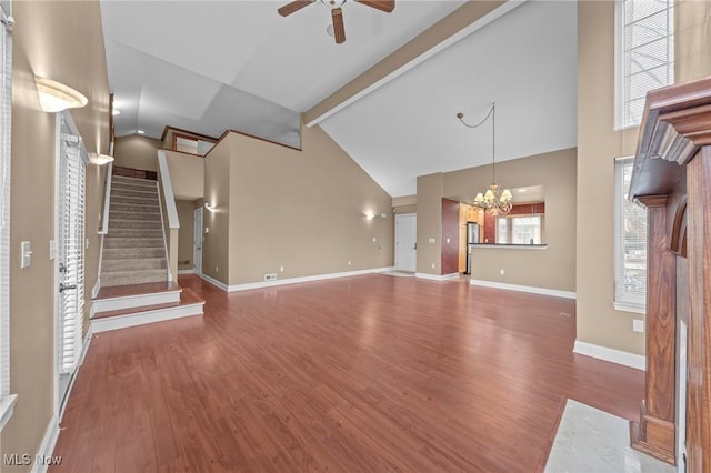 unfurnished living room featuring ceiling fan with notable chandelier, high vaulted ceiling, beamed ceiling, and hardwood / wood-style flooring