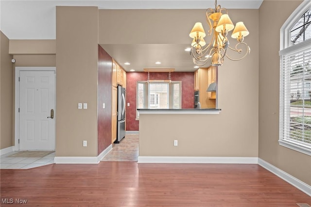 interior space featuring a chandelier and light hardwood / wood-style floors