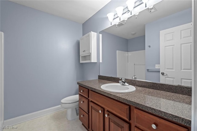 bathroom with vanity, a shower, and toilet