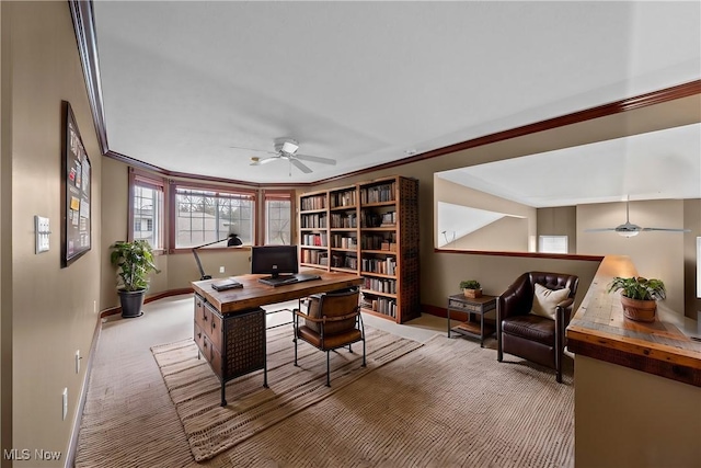 home office featuring ornamental molding, light colored carpet, and ceiling fan