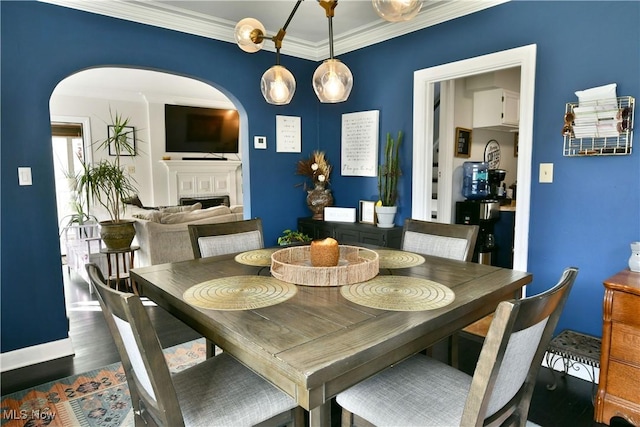 dining area featuring dark hardwood / wood-style flooring and crown molding