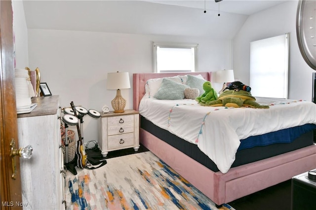 bedroom featuring vaulted ceiling and hardwood / wood-style floors