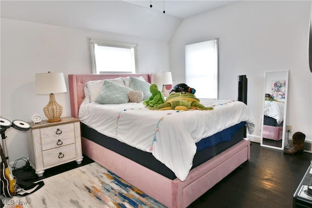 bedroom featuring dark wood-type flooring and vaulted ceiling