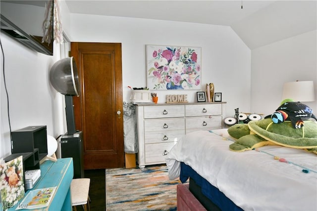 bedroom featuring hardwood / wood-style floors and vaulted ceiling