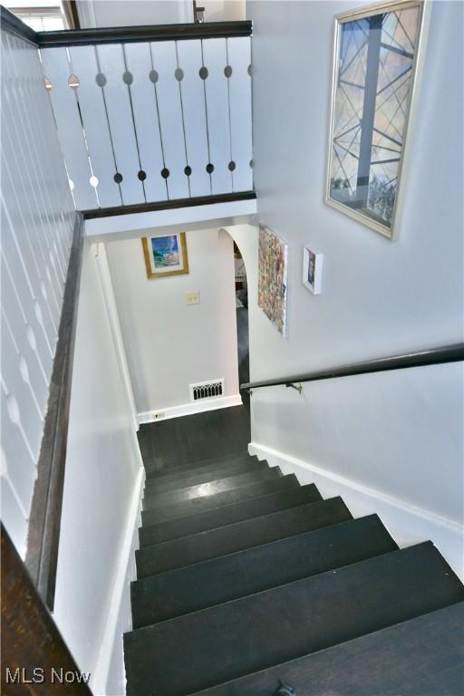 stairway with hardwood / wood-style floors