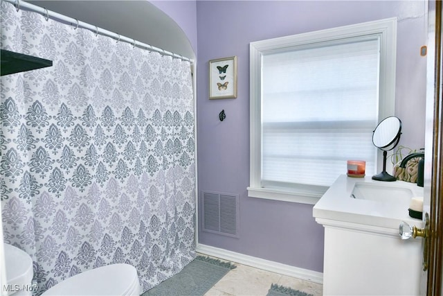 bathroom with vanity, tile patterned flooring, and toilet