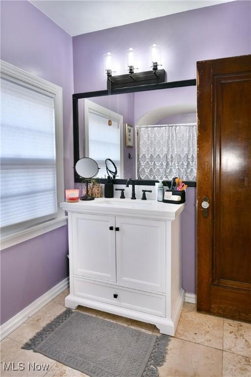 bathroom with tile patterned flooring, vanity, and a shower with curtain