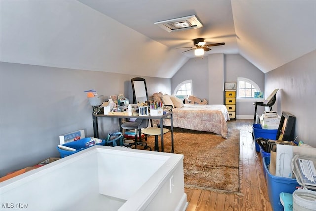 bedroom with hardwood / wood-style flooring, lofted ceiling, and ceiling fan