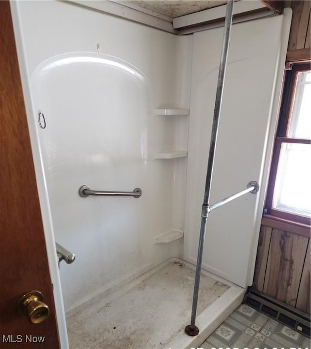 bathroom featuring a healthy amount of sunlight and walk in shower