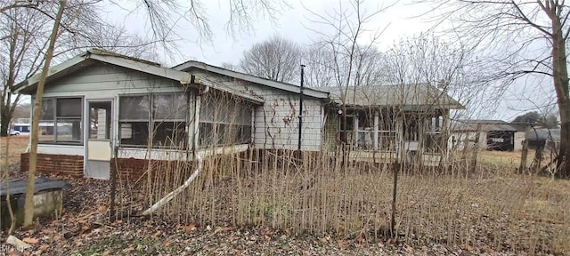 view of side of home featuring a sunroom