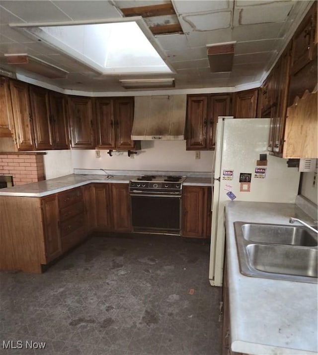 kitchen with sink, electric range, and wall chimney exhaust hood