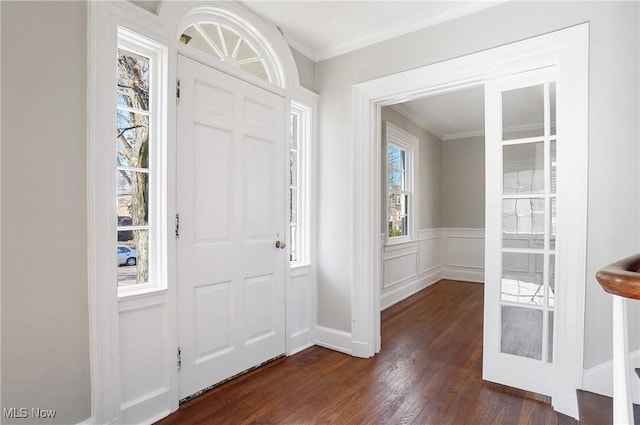 foyer featuring crown molding and dark hardwood / wood-style floors