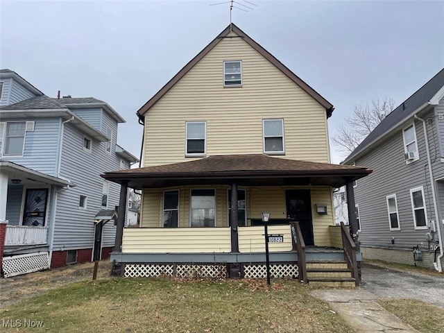 view of front of home featuring a porch and a front yard