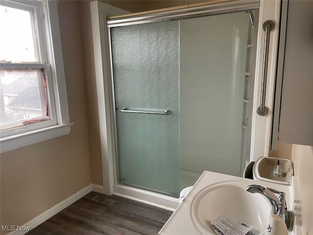 bathroom with hardwood / wood-style flooring, vanity, and an enclosed shower