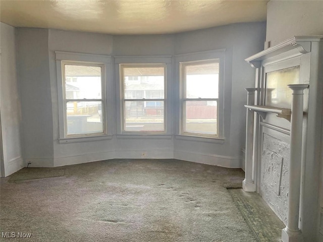 empty room with carpet floors and baseboards