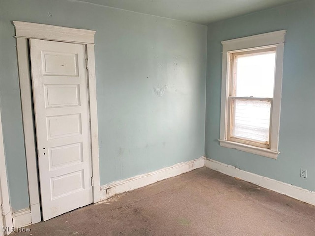 unfurnished room featuring baseboards