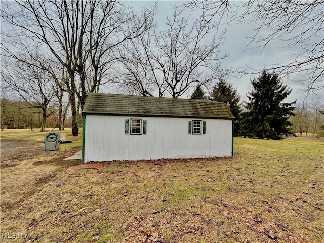 view of outbuilding featuring a lawn