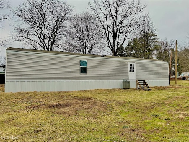 exterior space with a yard and cooling unit