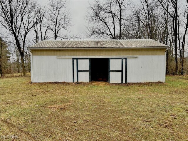 view of outbuilding with a lawn