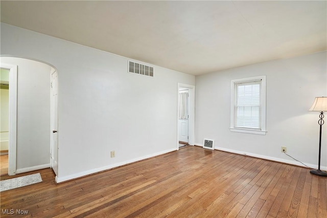 spare room with hardwood / wood-style floors