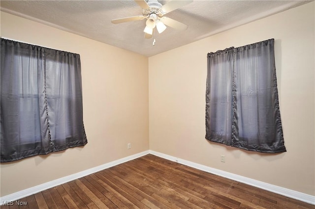 unfurnished room featuring hardwood / wood-style flooring, ceiling fan, and a textured ceiling