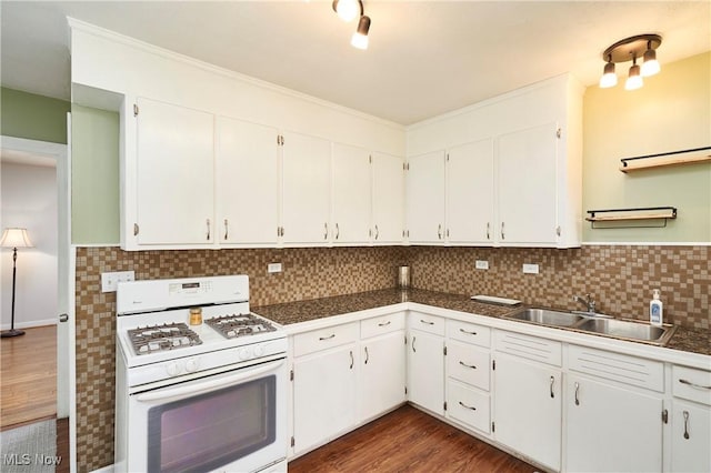 kitchen featuring white cabinetry, sink, and white gas stove