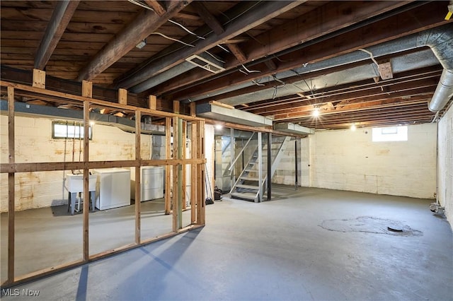 basement featuring sink and independent washer and dryer