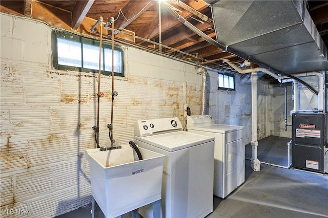 laundry room with heating unit, sink, and independent washer and dryer