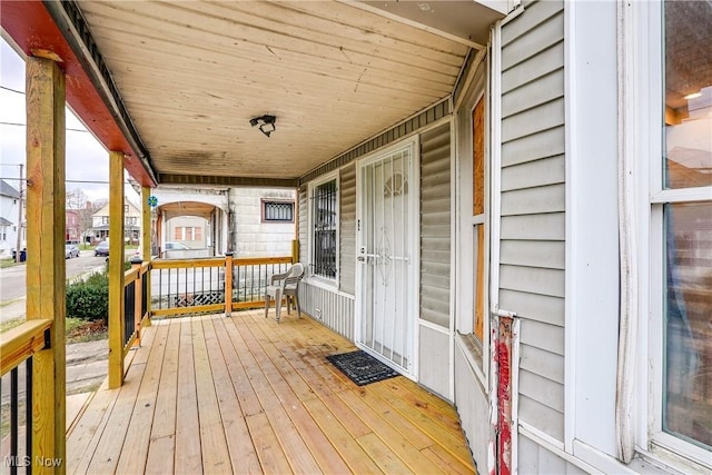 wooden terrace featuring covered porch