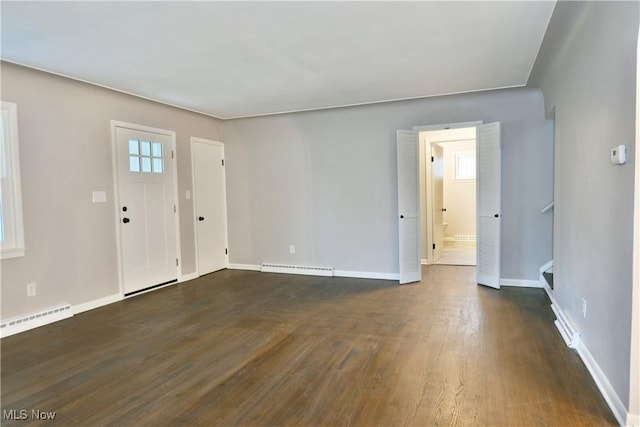 foyer entrance featuring a baseboard radiator and dark hardwood / wood-style floors